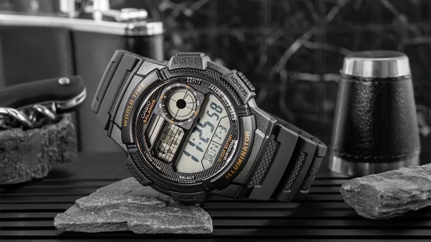 P&aacute;nsk&eacute; n&aacute;ramkov&eacute; hodinky Casio AE-1000W-5AVEF vystaven&eacute; u kamene
