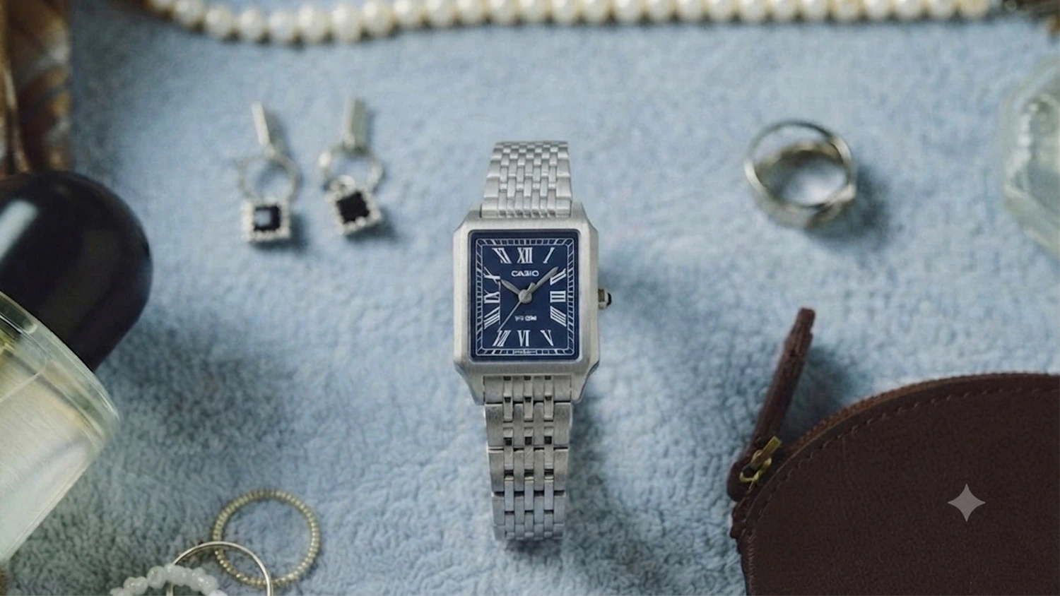 Hodinky Casio LTP-B190D-2BVER na podložke so šperkami a parfumom