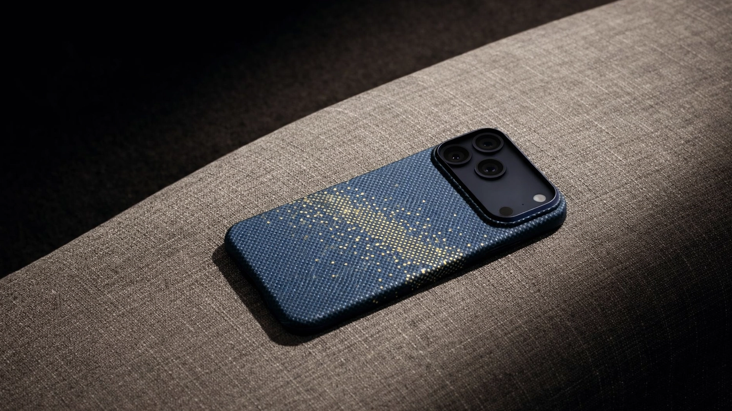 iPhone v krytu Pitaka položen&yacute; na pohovce