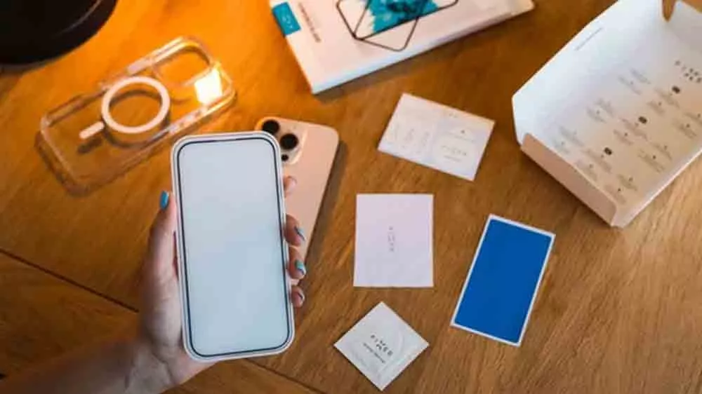 Mobiln&iacute; telefon chr&aacute;něn&yacute; sklem Fixed s kompletn&iacute; instalačn&iacute; sadou na stole_01