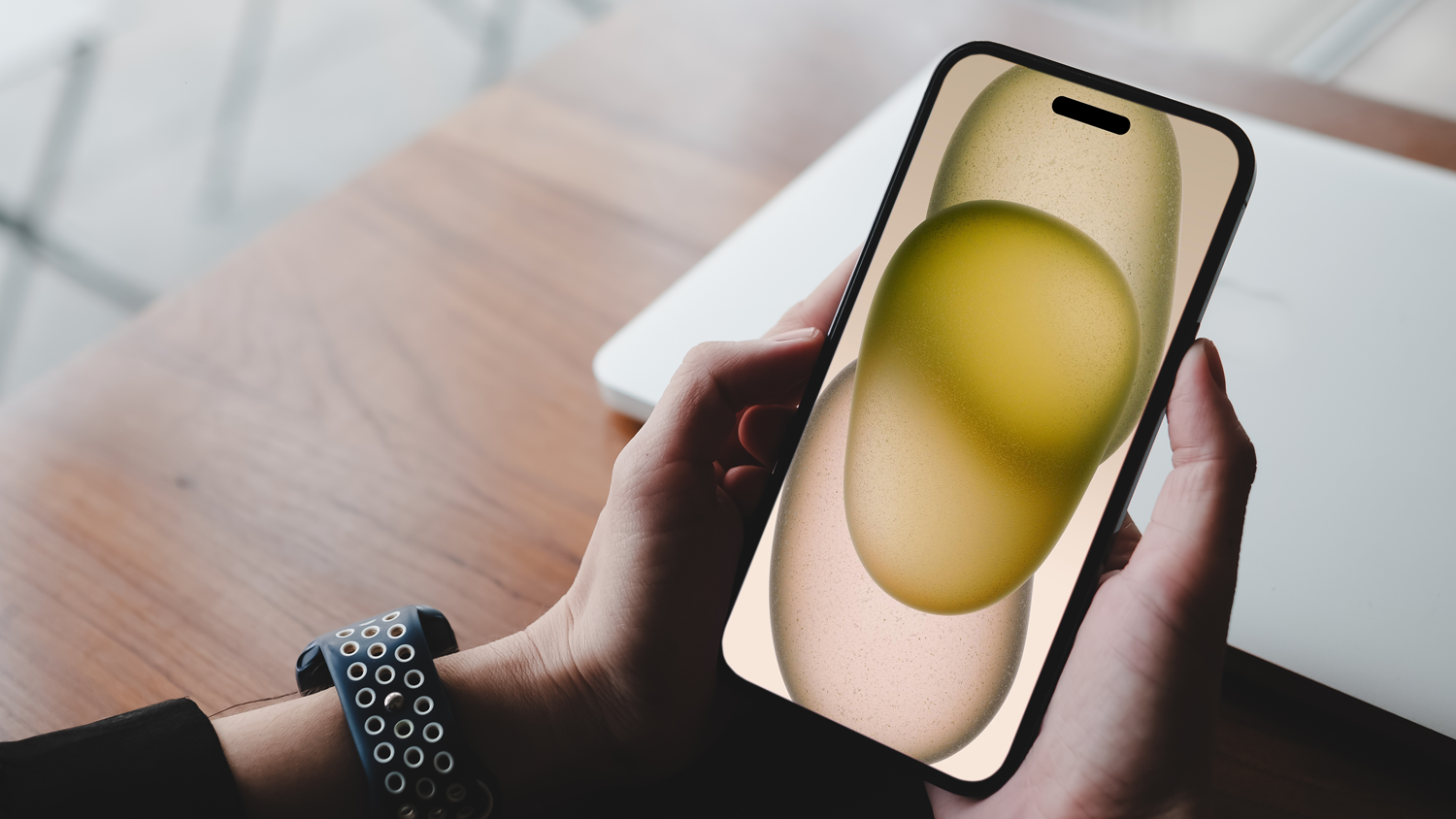 Osoba drží v ruke iPhone.