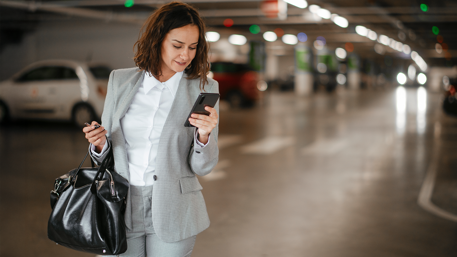 Žena se d&iacute;v&aacute; na mobiln&iacute; telefon