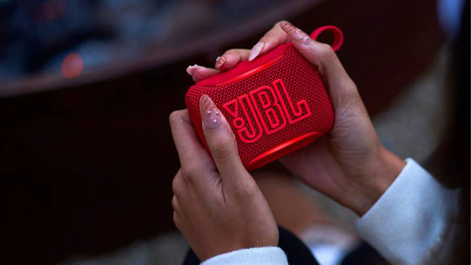 Ženské ruce drží reproduktor JBL GO5