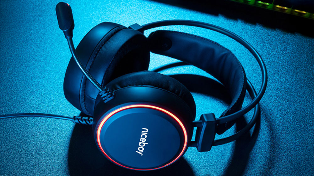 Položená sluchátka Niceboy Oryx X220 Iris na stole ve tmě_02