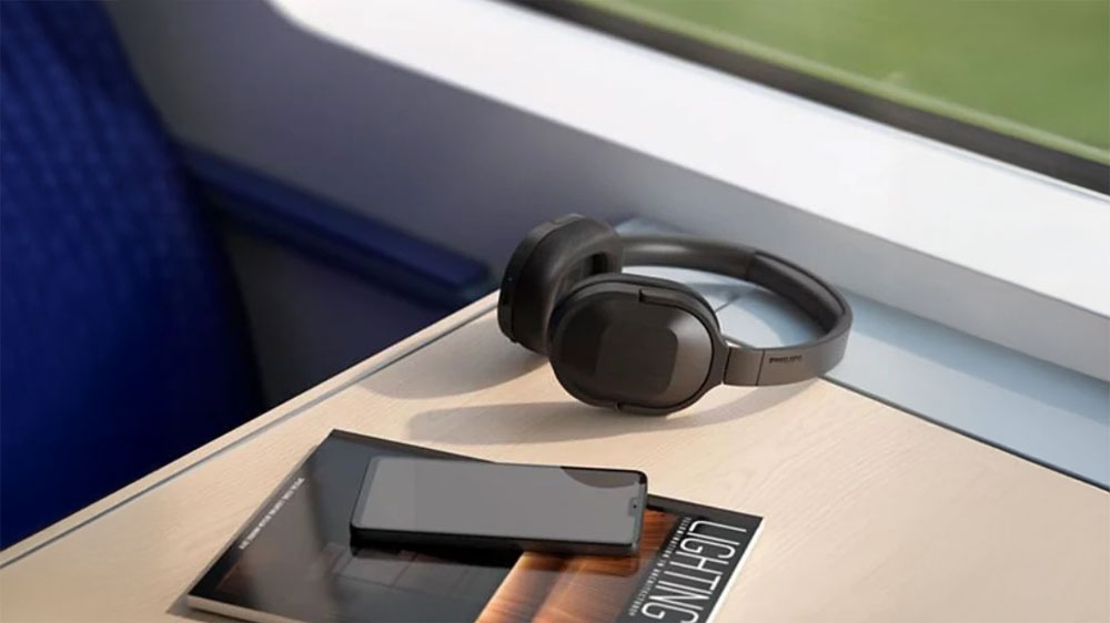 Položen&aacute; sluch&aacute;tka Philips TAH6506BK/00 ve vlaku na stolečku_03