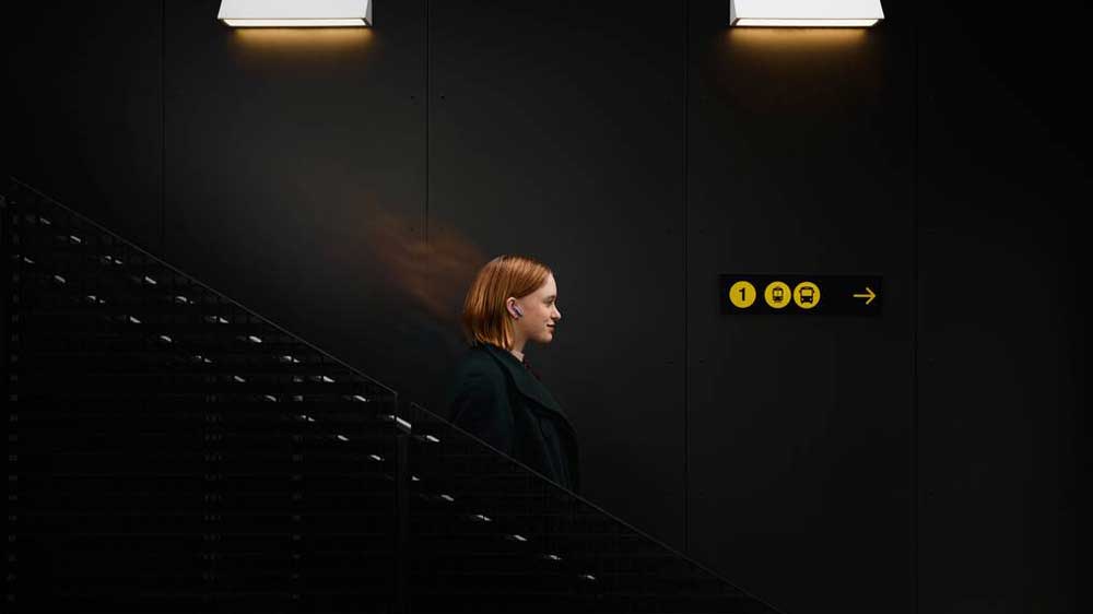 Žena využívá adaptivní potlačení hluku na sluchátkách JBL Live Flex 3_04