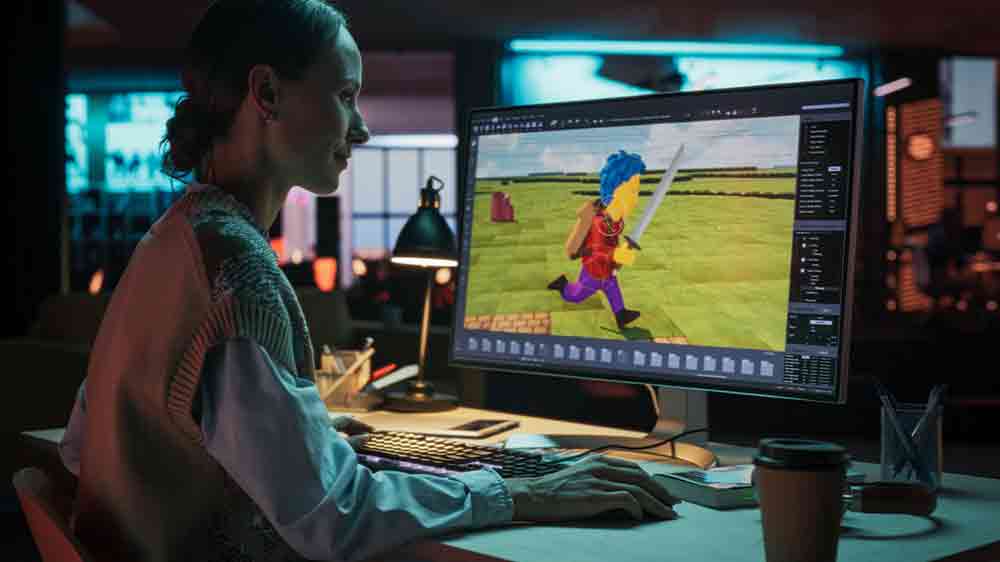 Mladá žena sedící u stolního počítače a hrající PC hru_02