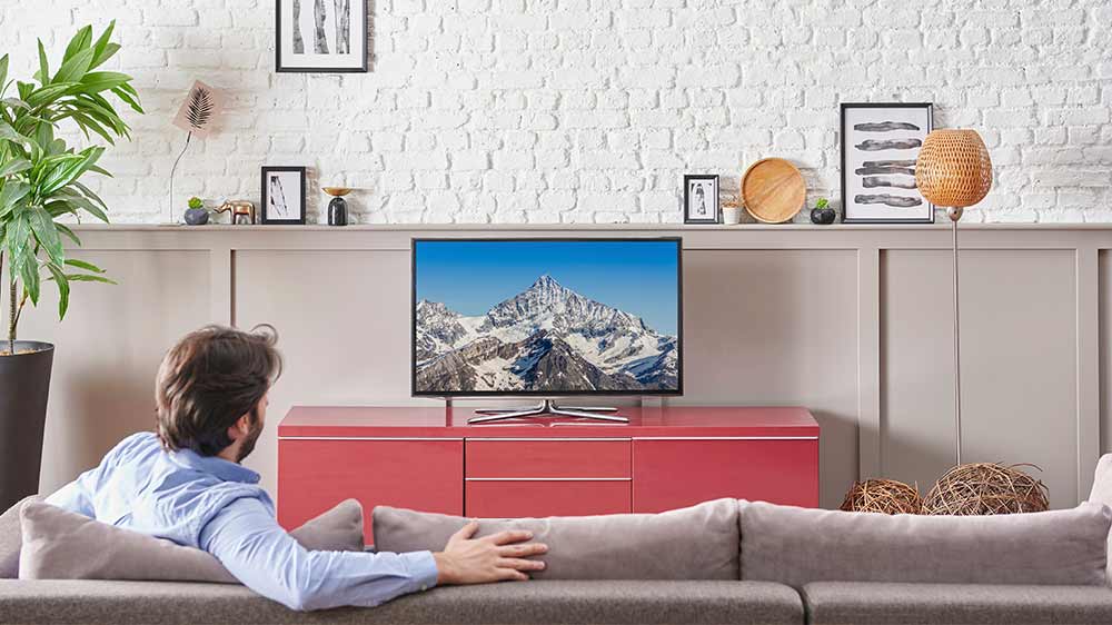 Muž sledující televizi v obýváku_04
