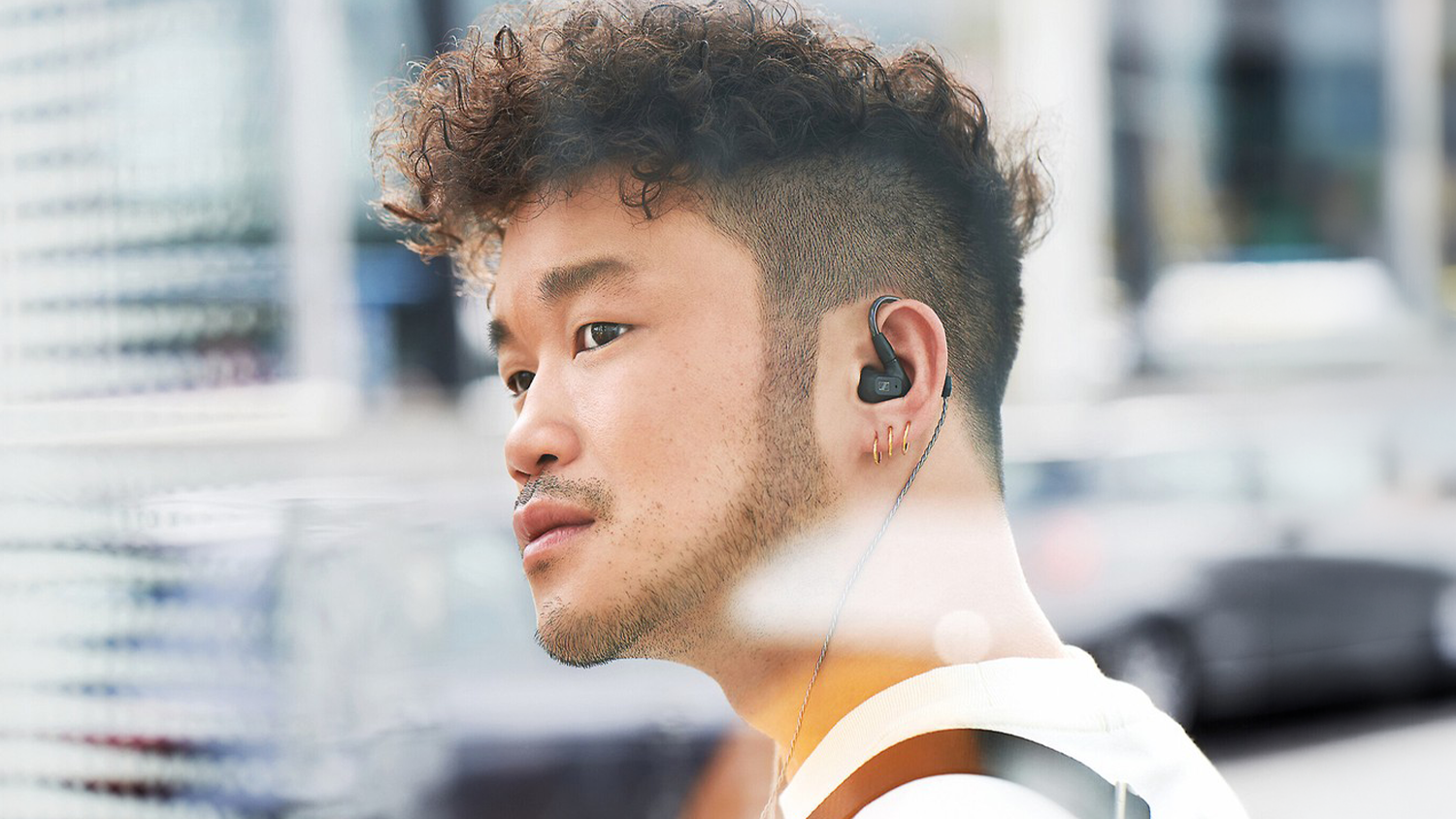Ľavý profil muža so slúchadlami Sennheiser IE 200 na ušiach