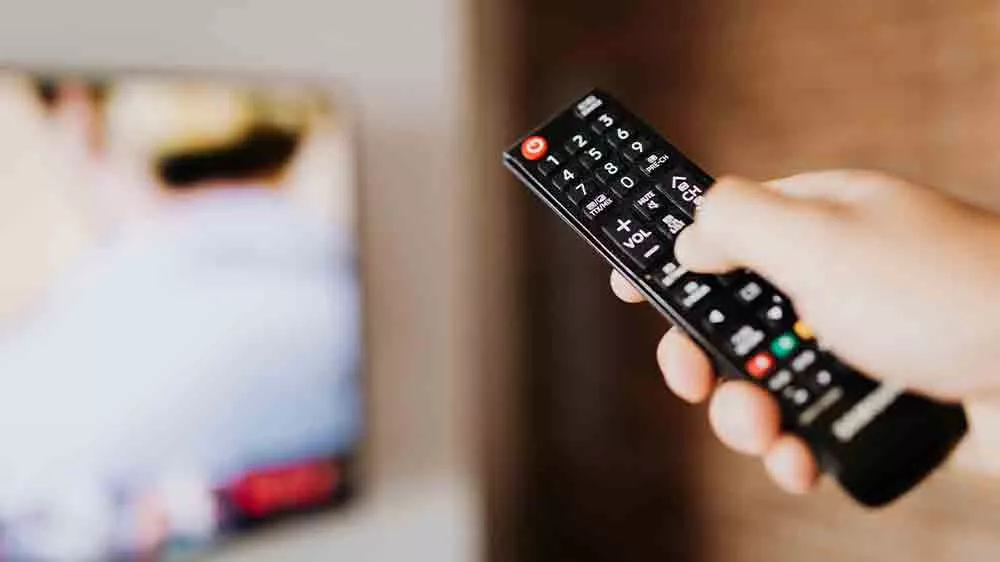 Ruka m&iacute;ř&iacute;c&iacute; ovladačem na televizi_04