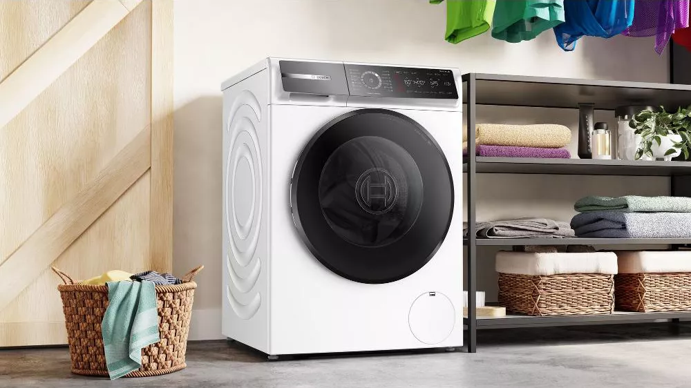 Ustavená pračka vedle regálu Bosch WGB24410BY_03
