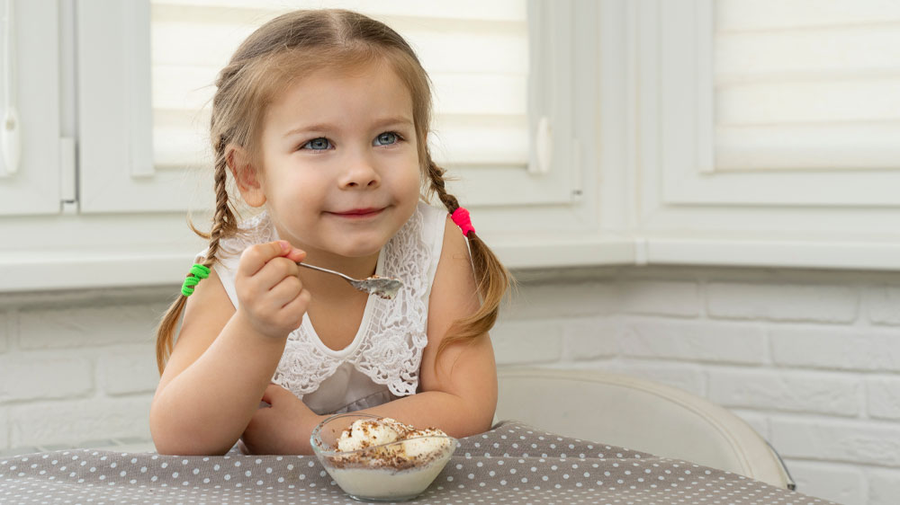 Děvčátko jí domácí zmrzlinu ze skleněné misky_02