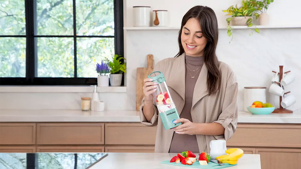 Žena pripravujúca si smoothie v mixéri Nutribulet Portable NBP003LBL_02