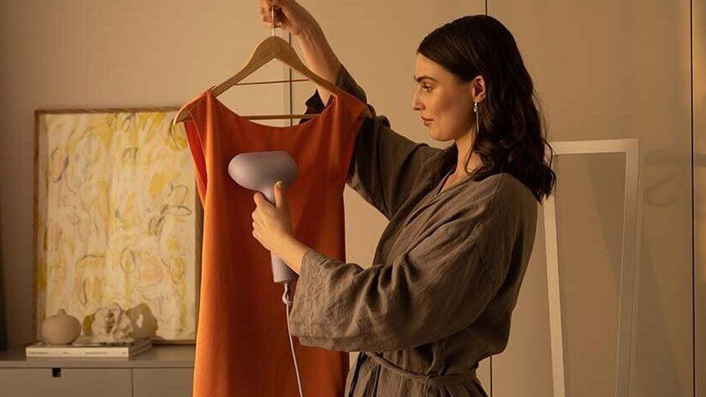Žena žehlí šaty na ramínku_02