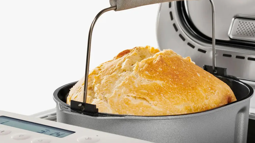 Vyndávání odnímatelné pečící nádoby s upečeným chlebem z domácí pekárny_02