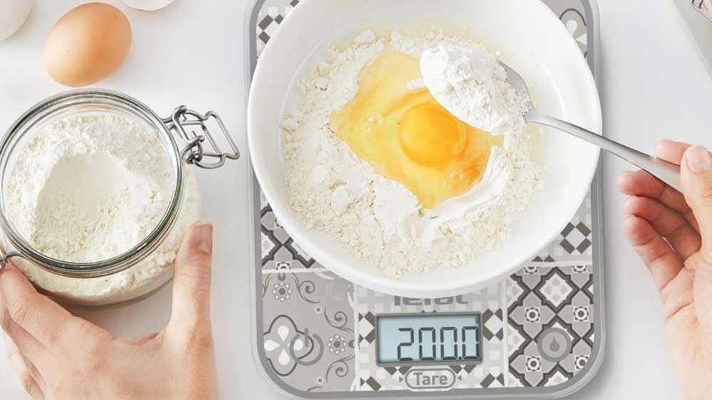 Člověk vážící suroviny na kuchyňské váze Tefal BC50D6V0 Optiss_03