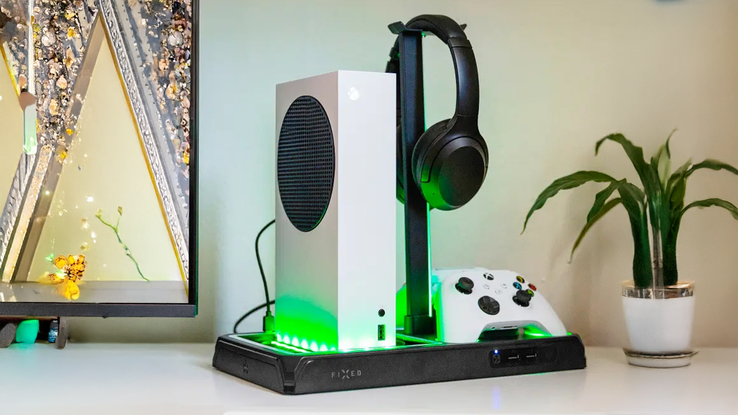 Multifunkční stanice Fixed pro Xbox Series X/S černá s umístěným příslušenstvím vedle televize