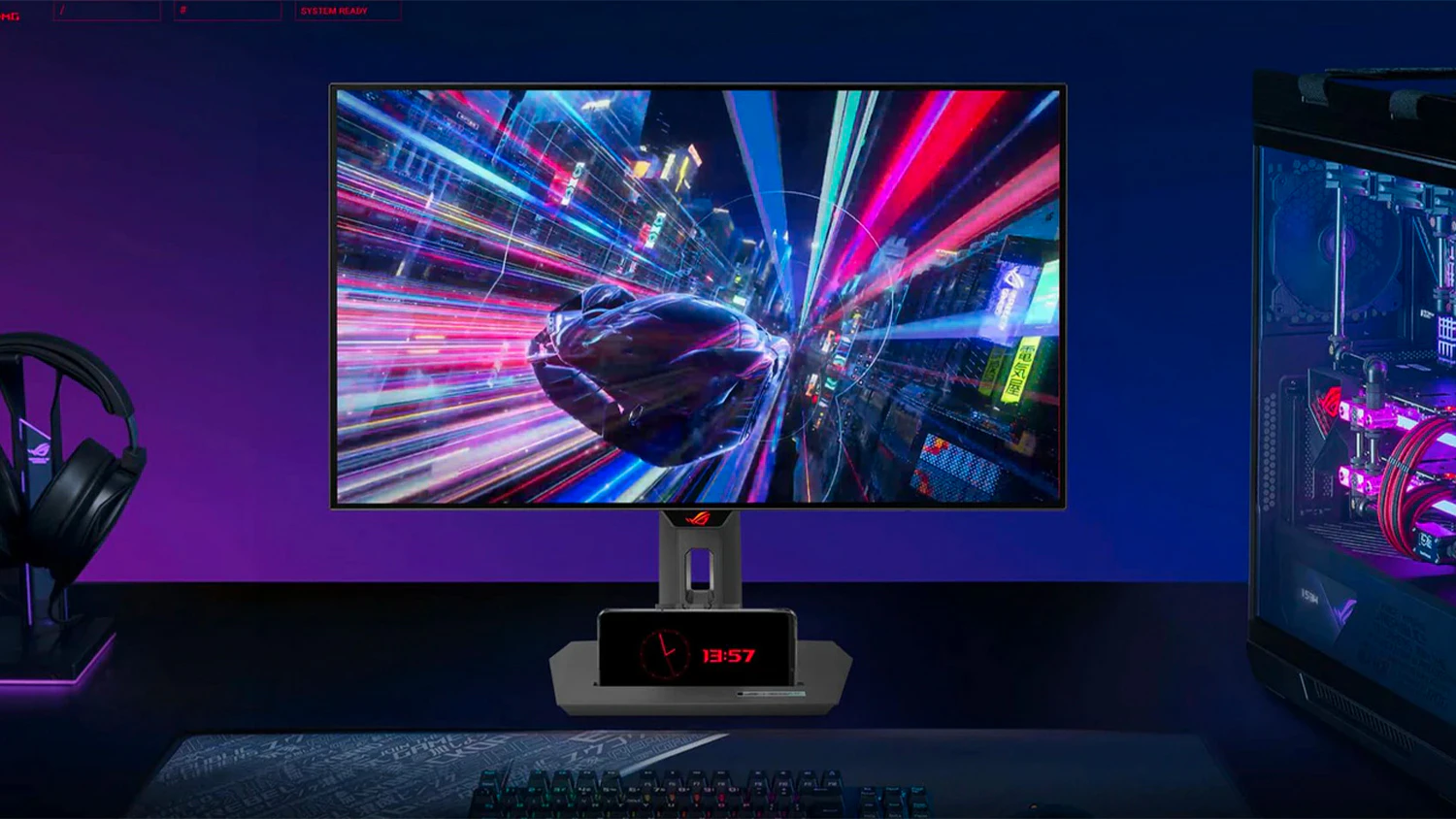 ASUS ROG Strix OLED XG27ACDNG na stole s telef&oacute;nom v stojane