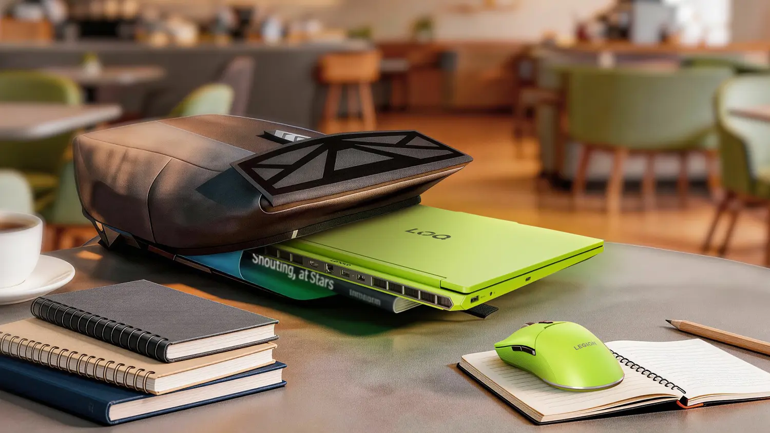 Stůl v kav&aacute;rně s batohem a notebookem Lenovo