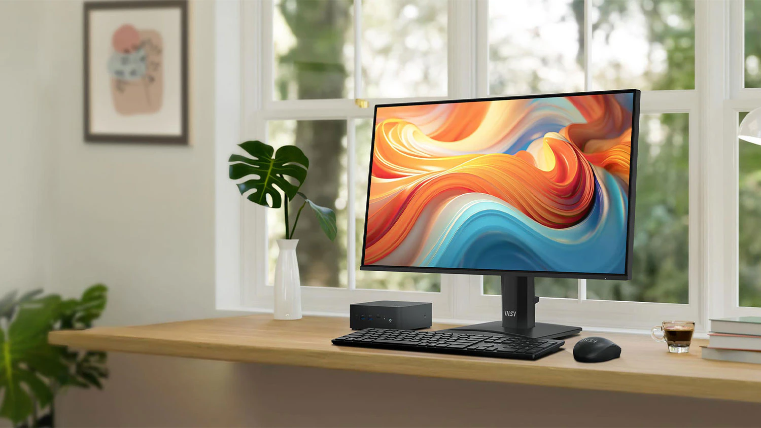 Pracovní stůl u okna s rostlinami a monitor MSI