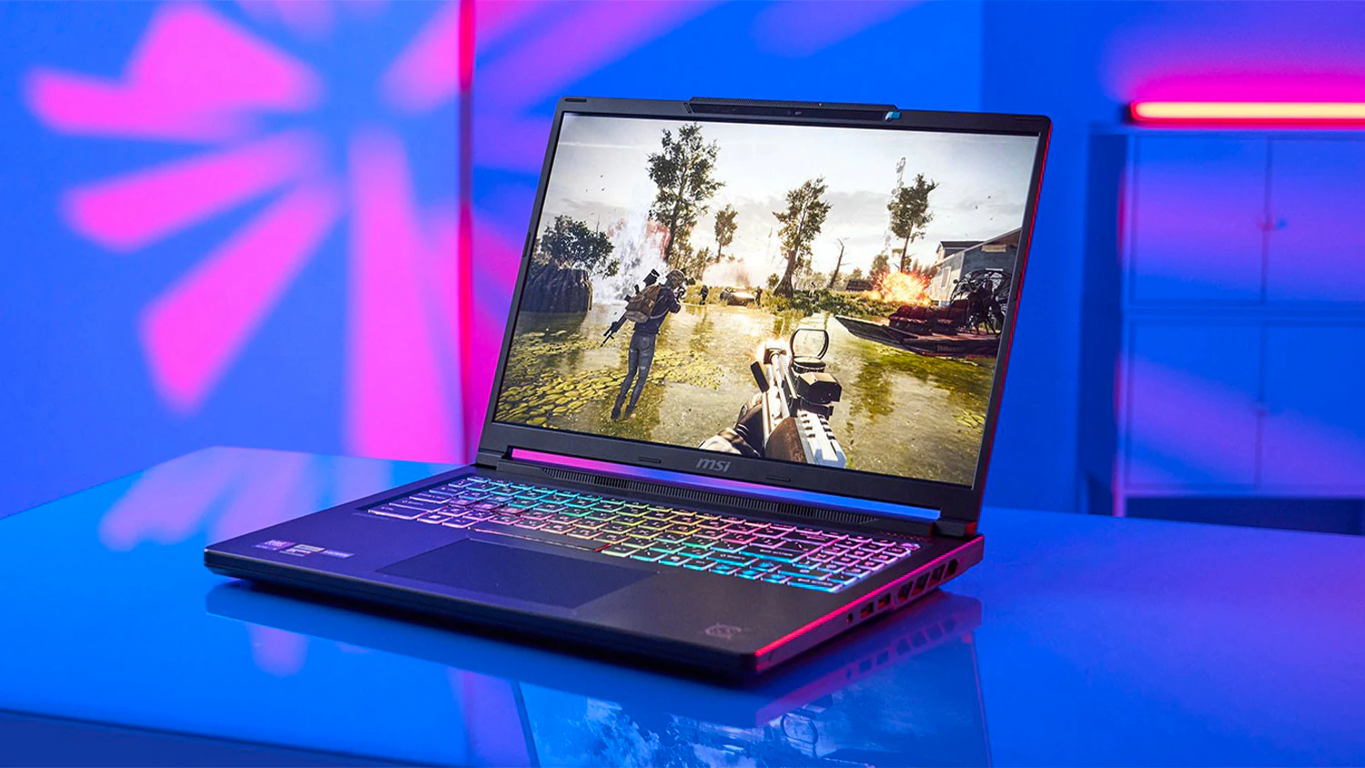 Modré pozadí s notebookem MSI na stole
