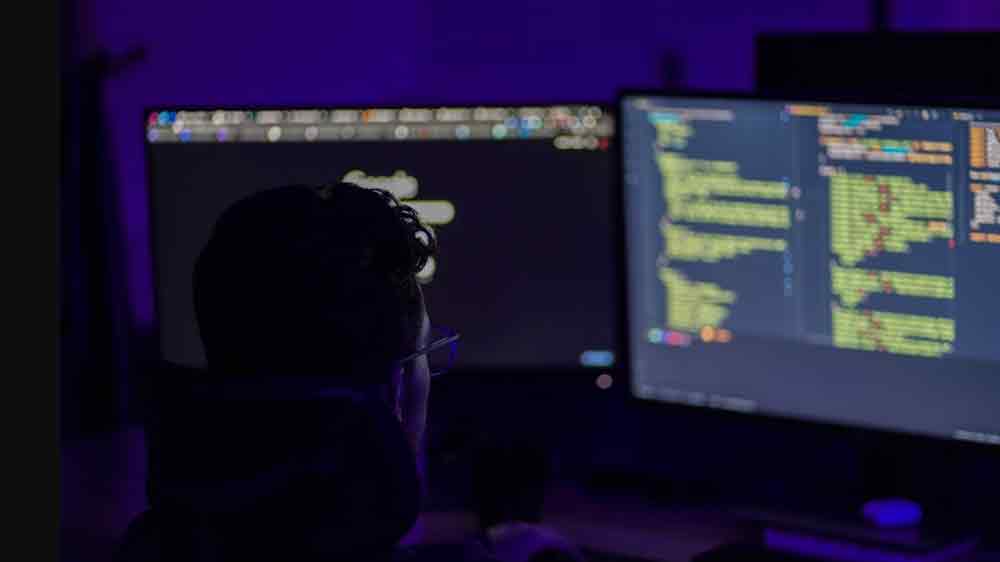 Muž pri poč&iacute;tači s dvomi monitormi_03
