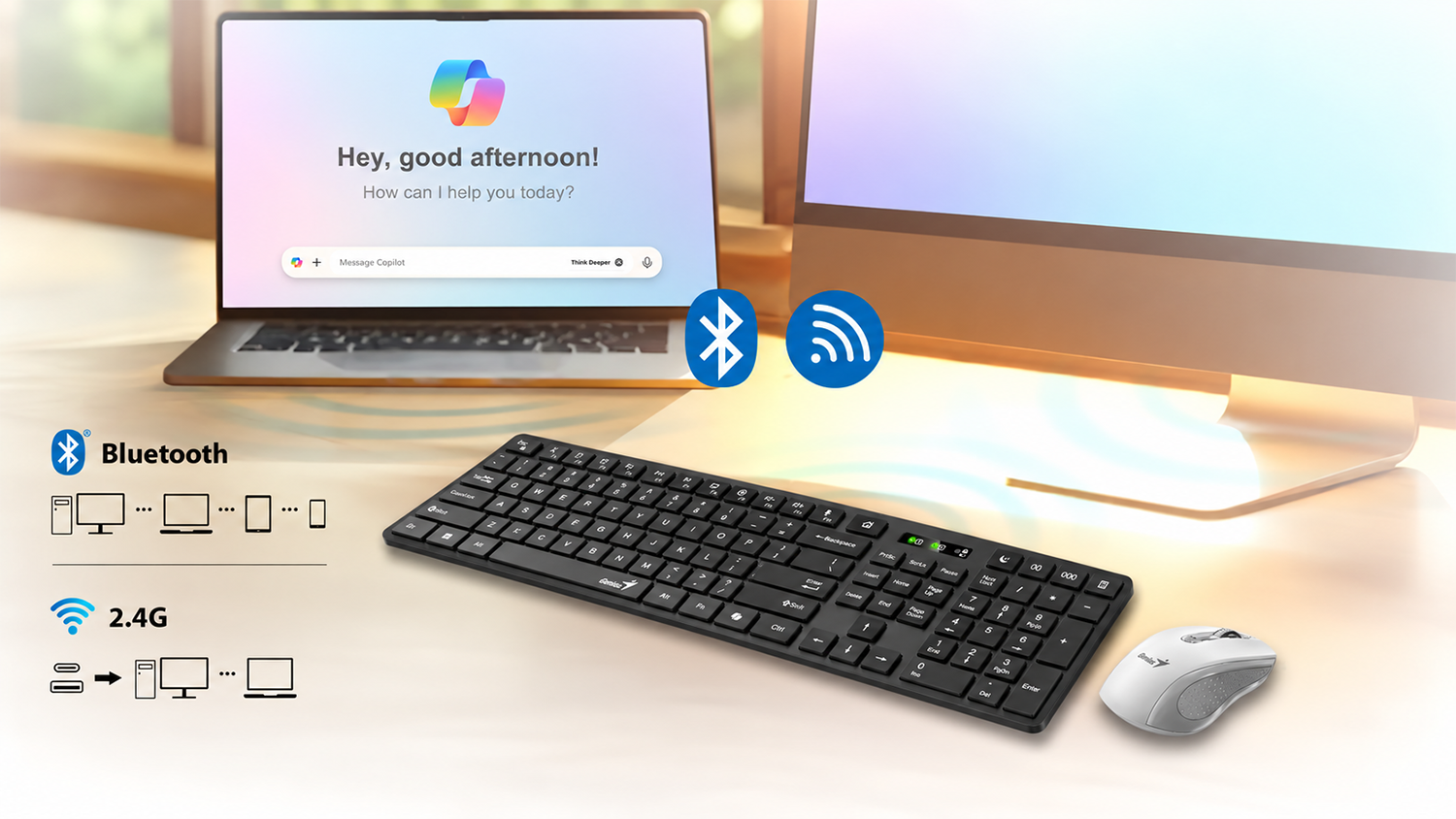 Bezdrátová klávesnice Genius SlimStar 7250BT Copilot na stole vedle notebooku a monitoru