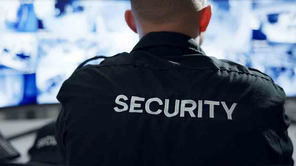 Muž s n&aacute;pisem security na bundě hl&iacute;d&aacute; objekt_02
