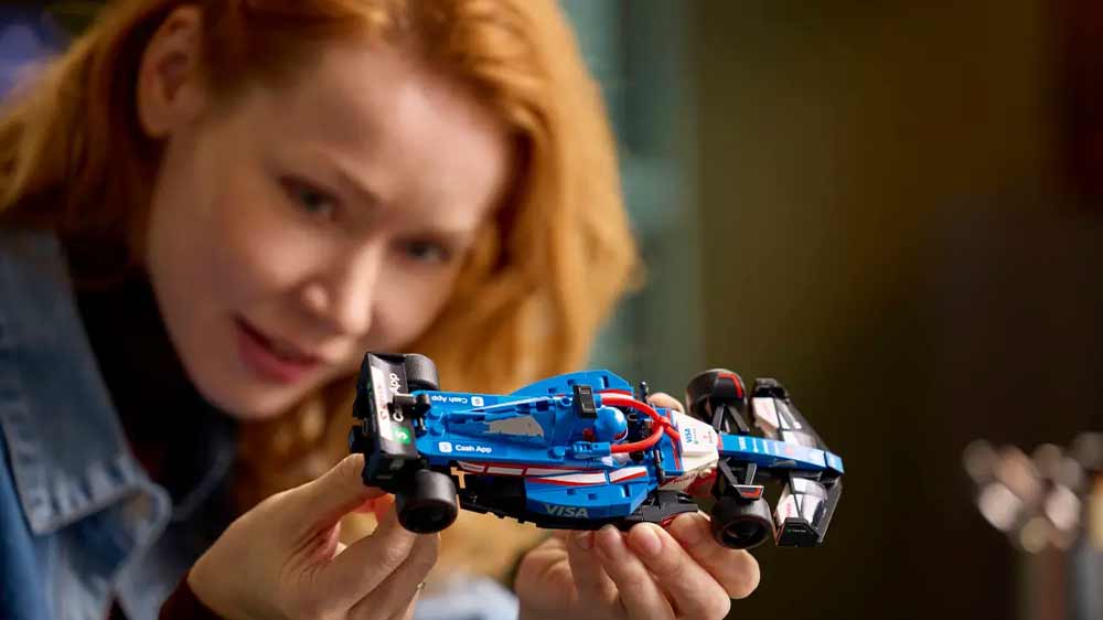 LEGO® Speed Champions™ 77246 Závodní auto Visa Cash App RB VCARB 01 F1® – dívka drží v rukou model auta_03