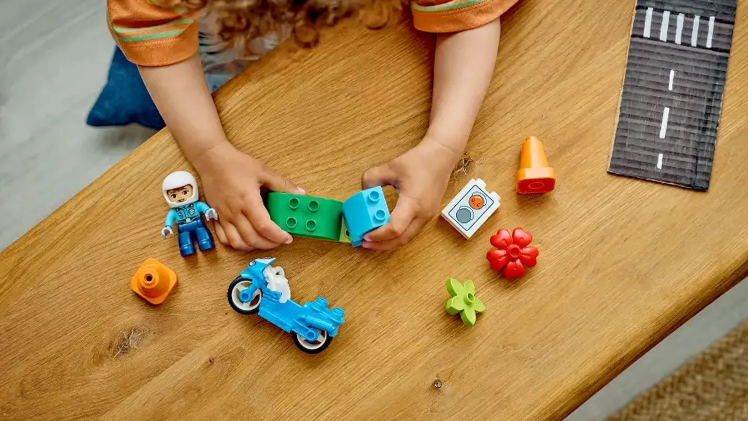 Mal&yacute; chlapec sestavuje stavebnici LEGO&reg; DUPLO&reg; 10471 Modr&aacute; policejn&iacute; motorka