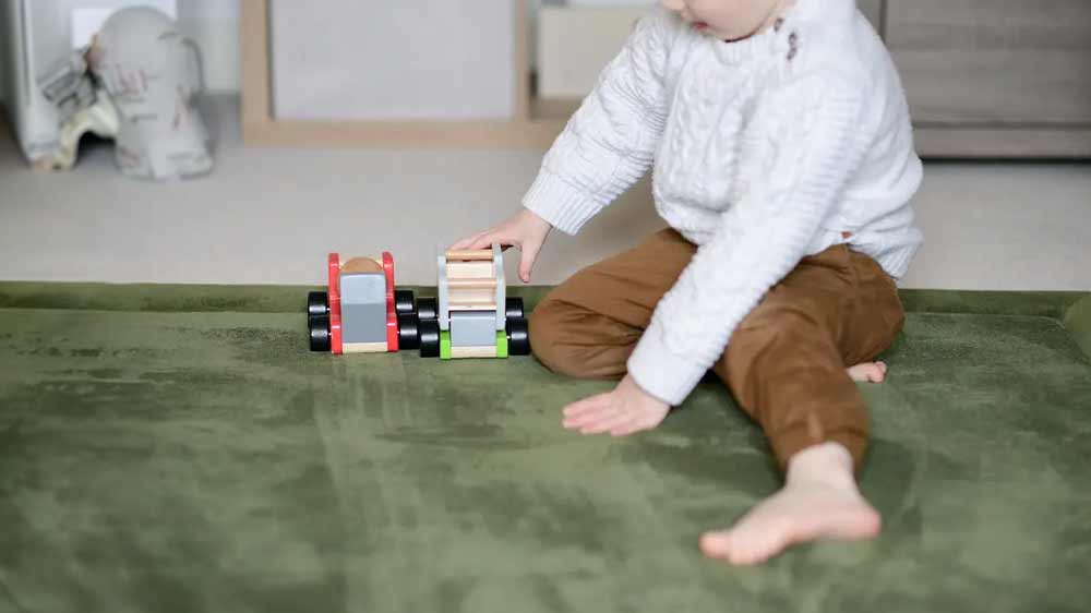 Dítě hrající si na olivovém koberci olivový MOMOMI 200 × 300 cm_03