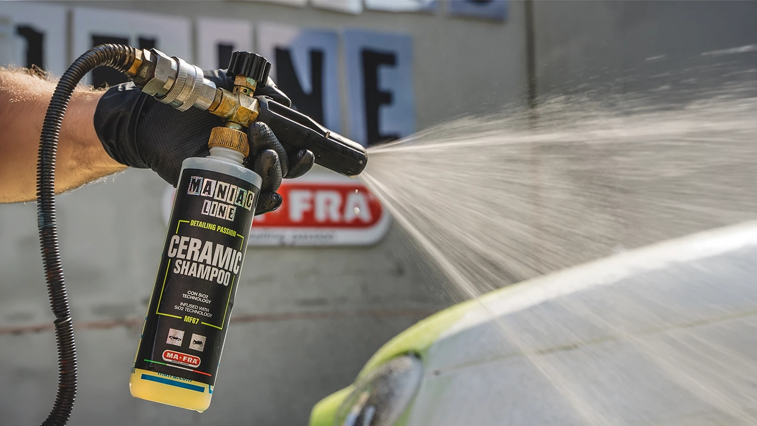Ruka drží keramický šampón MANIAC 500 ml (MF-67) pripojený k rozprašovaču a nastrieka prostriedok na auto