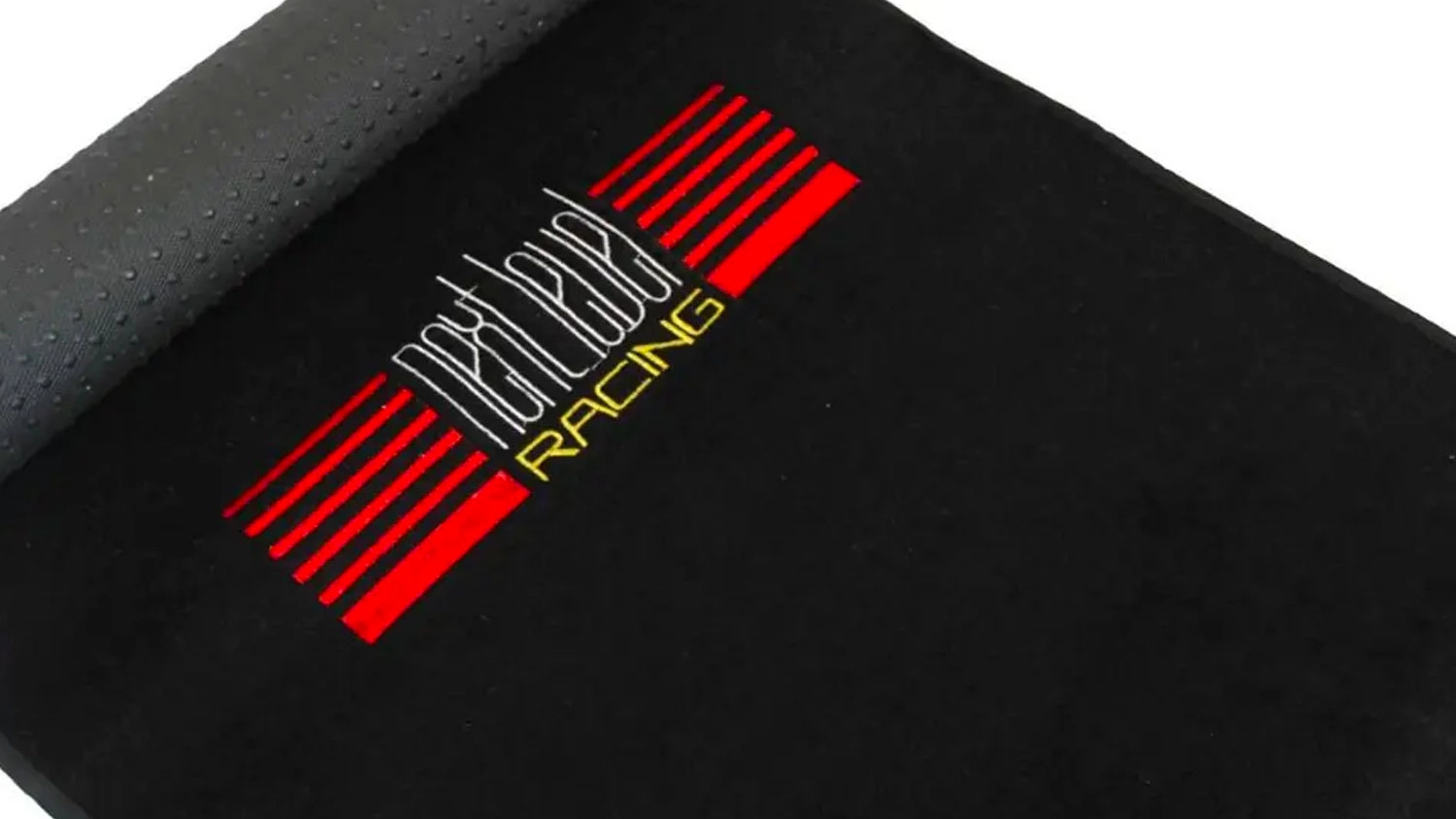 Čierna podložka Next Level Racing s červeno-bielym logom a textúrovanou protišmykovou spodnou stranou.