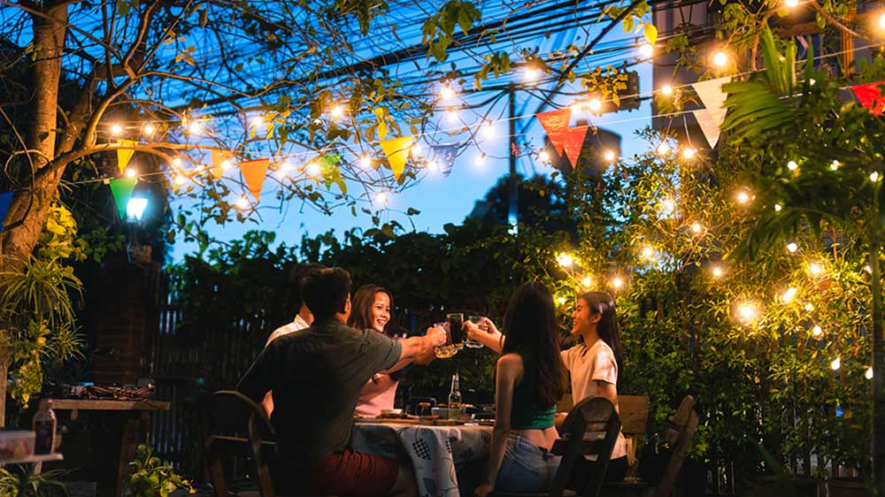 Parta lid&iacute; sed&iacute; večer u stolu na zahradě_02